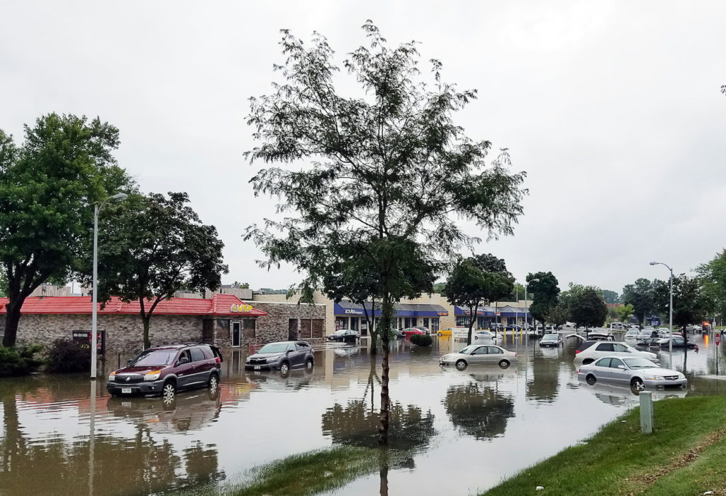 Businesses and cars flooded along street