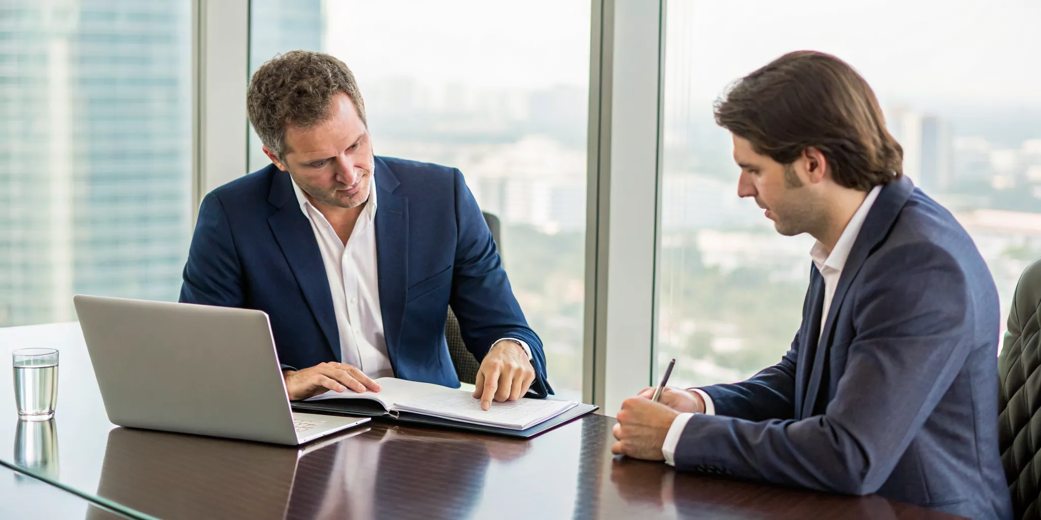 Two lawyers discussing the steps for suing someone while reviewing legal documents.